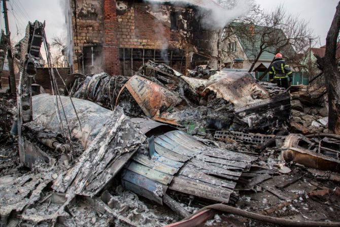 Un bombero ucraniano camina entre las ruinas de un avión derribado en Kyiv, Ucrania, el 25 de febrero.