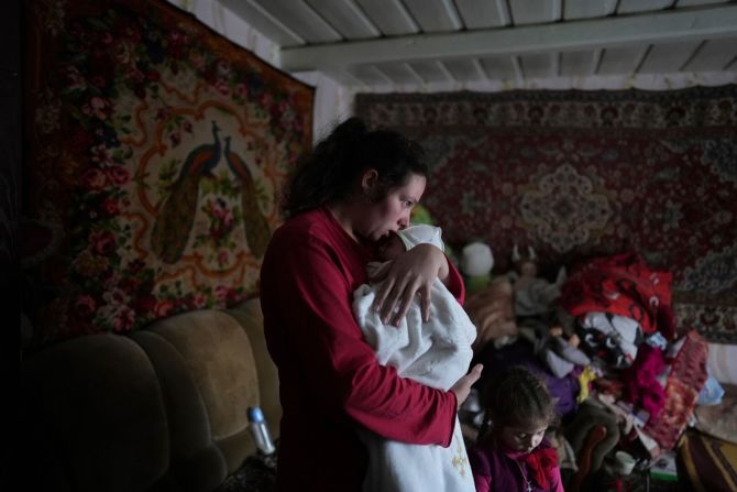 Anastasia Manha arrulla a su hijo Mykyta de dos años después del supuesto bombardeo de las fuerzas separatistas en Novohnativka, Ucrania, el 20 de febrero.