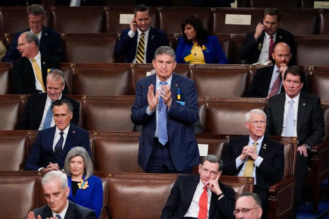 El senador Joe Manchin, demócrata de Virginia Occidental, se pone de pie y aplaude mientras se sienta entre los senadores republicanos. J. Scott Applewhite/Piscina/AP