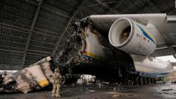 A Ukrainian serviceman walks by an Antonov An-225 Mriya aircraft destroyed during fighting between Russian and Ukrainian forces at the Antonov airport in Hostomel, Ukraine, Saturday, April 2, 2022. At the entrance to Antonov Airport in Hostomel Ukrainian troops manned their positions, a sign they are in full control of the runway that Russia tried to storm in the first days of the war.