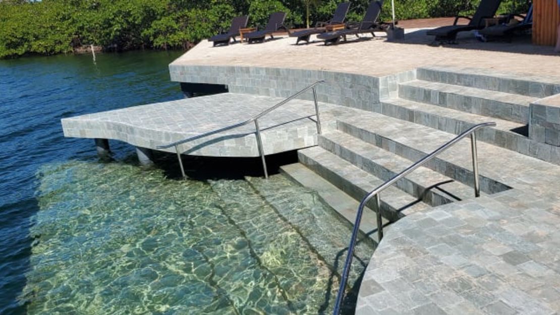 Las escaleras de azulejos de cuarzo verde descienden hacia las aguas de abajo. Bocas Bali