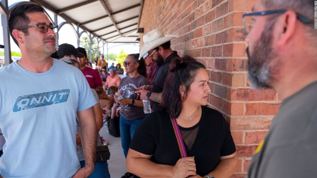 Michael Cavasos, 40, izquierda, Brenda Perez, 39, derecha, y Eduardo Galindo, 57, esperan en fila para donar sangre el día después del tiroteo masivo mortal.