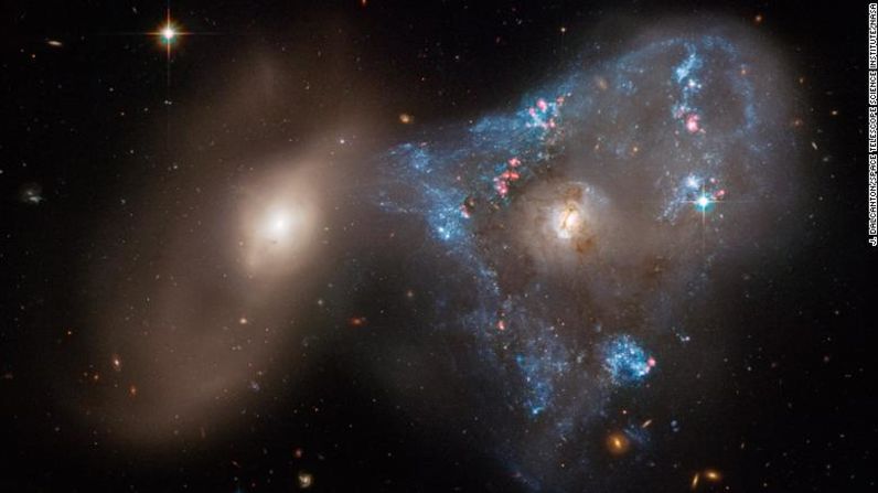 Una forma de triángulo inusual formada por dos galaxias que se unen en un tira y afloja cósmico ha sido capturada en una nueva imagen tomada por el telescopio espacial Hubble de la NASA. La colisión frontal entre las dos galaxias alimentó un frenesí de formación de estrellas, creando "el triángulo extraño de estrellas recién acuñadas".