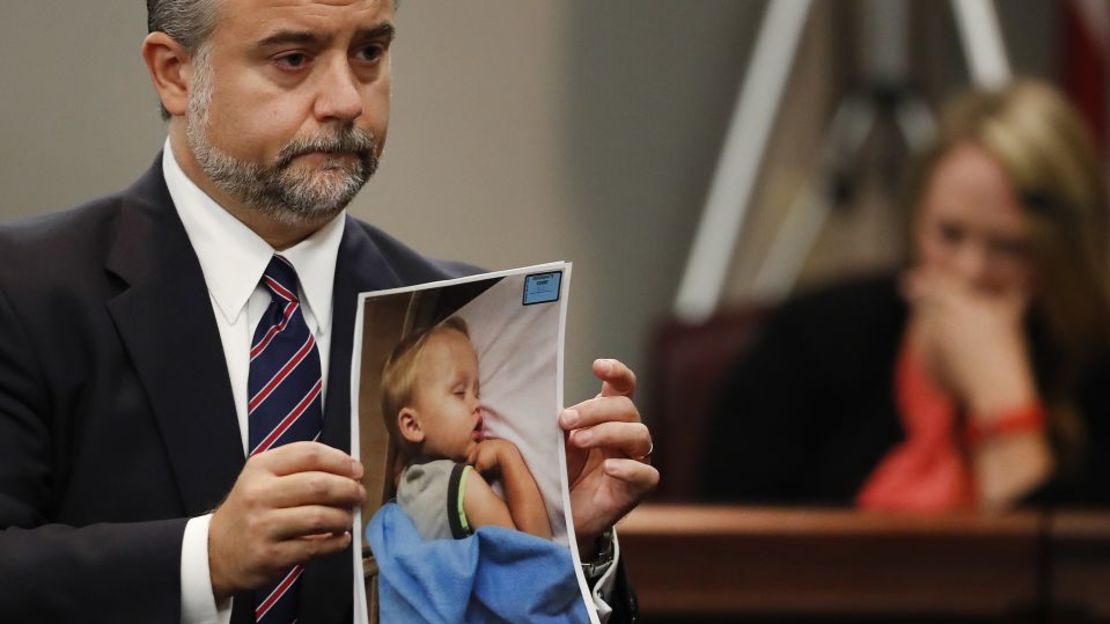 El abogado defensor Maddox Kilgore sostiene una foto de Cooper Harris durante el juicio por asesinato de Justin Ross Harris en 2016.