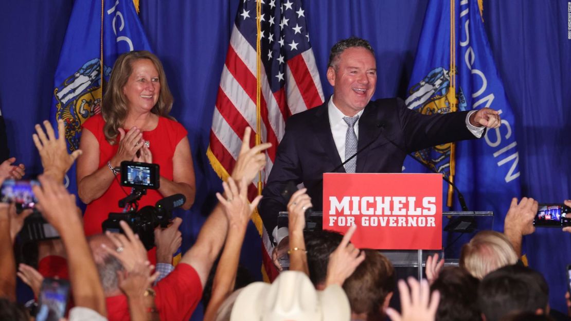 El candidato republicano a gobernador Tim Michels saluda a los invitados con su esposa, Barbara Michels, en un mitin la noche de las elecciones el 9 de agosto de 2022 en Waukesha, Wisconsin.