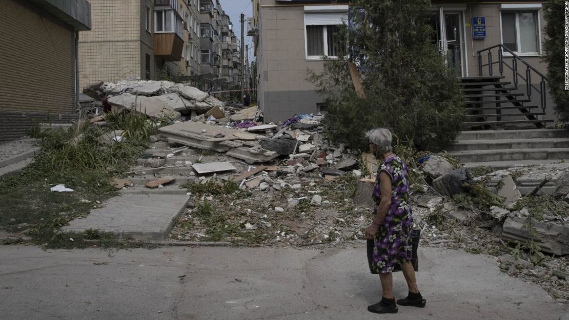 Una mujer evalúa los daños en una calle de Nikopol, donde los residentes dicen que viven bajo un incesante bombardeo de cohetes.