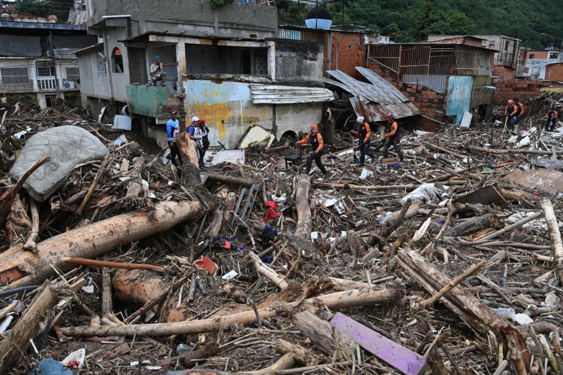 Rescatistas y residentes buscan entre los escombros de casas destruidas víctimas o sobrevivientes de un deslizamiento de tierra durante fuertes lluvias en Las Tejerias, estado de Aragua, Venezuela, el 9 de octubre de 2022. Crédito: YURI CORTEZ/AFP vía Getty Images