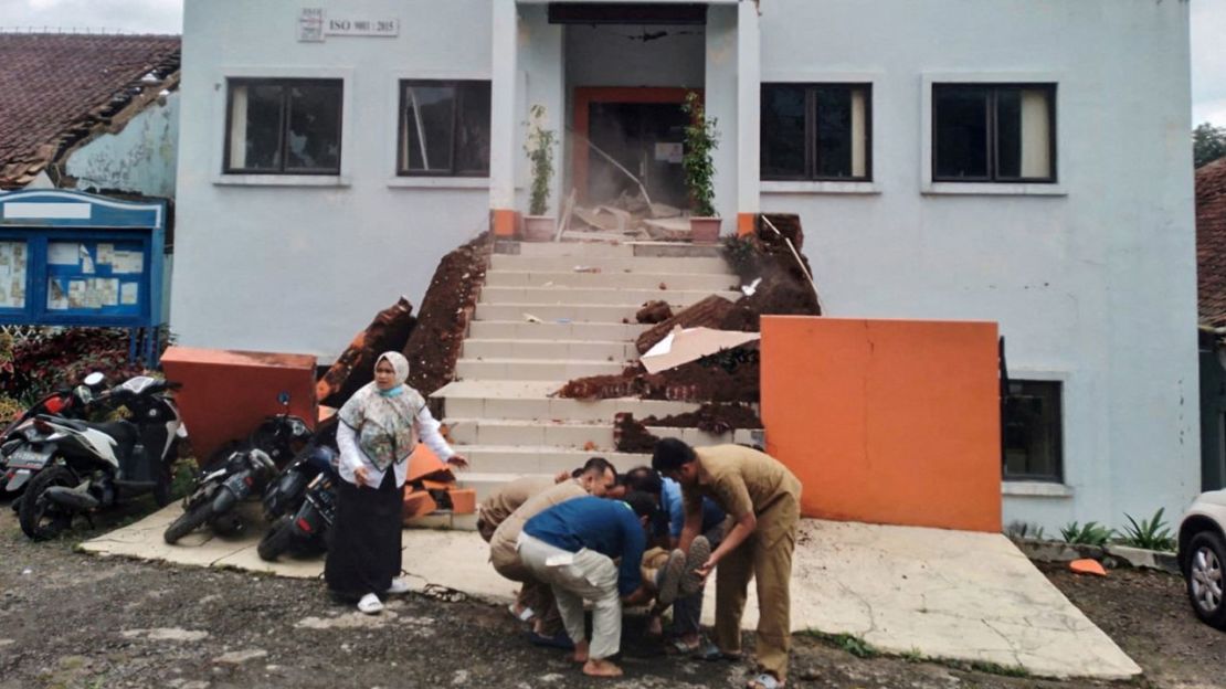 Agentes municipales de Cianjur evacuan a un compañero herido tras el terremoto.