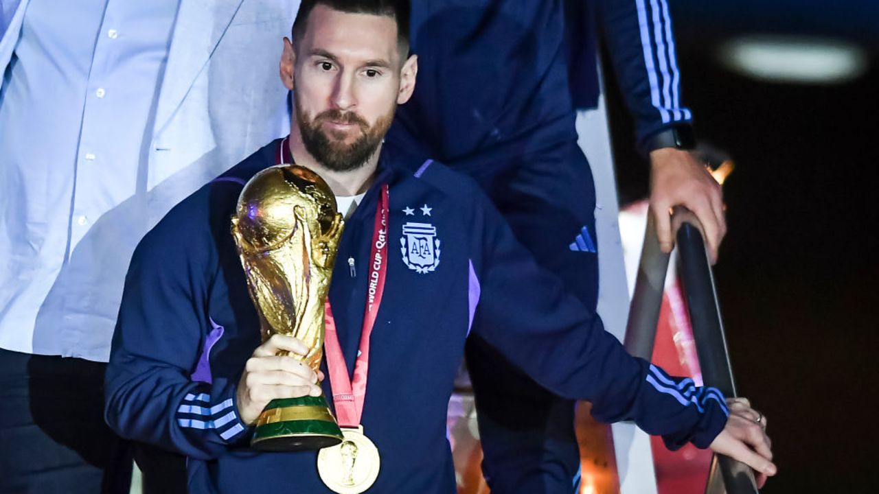 BUENOS AIRES, ARGENTINA - DECEMBER 20: Lionel Messi of Argentina holds the FIFA World Cup during the arrival of the Argentina men's national football team after winning the FIFA World Cup Qatar 2022 on December 20, 2022 in Buenos Aires, Argentina.