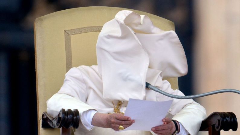 Una ráfaga de viento golpea el cuello de Benedicto en su cara en septiembre de 2012 durante su discurso semanal en la Plaza de San Pedro.