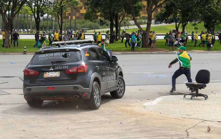 Simpatizantes de Bolsonaro atacan un vehículo de la Policía Militar durante enfrentamientos frente al Palacio Presidencial de Planalto en Brasilia este domingo.