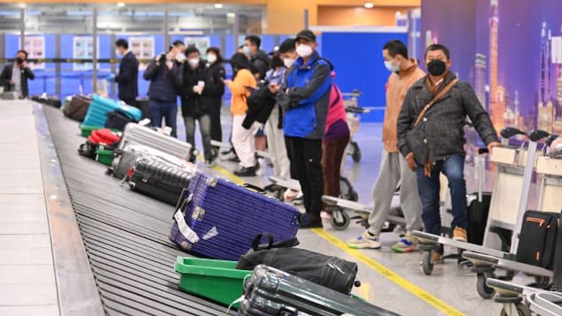 Viajeros esperan su equipaje en el área de reclamo de equipaje en el Aeropuerto Internacional de Shanghai Pudong mientras China levanta los requisitos de cuarentena para llegadas internacionales el 8 de enero de 2023 en Shanghai, China.