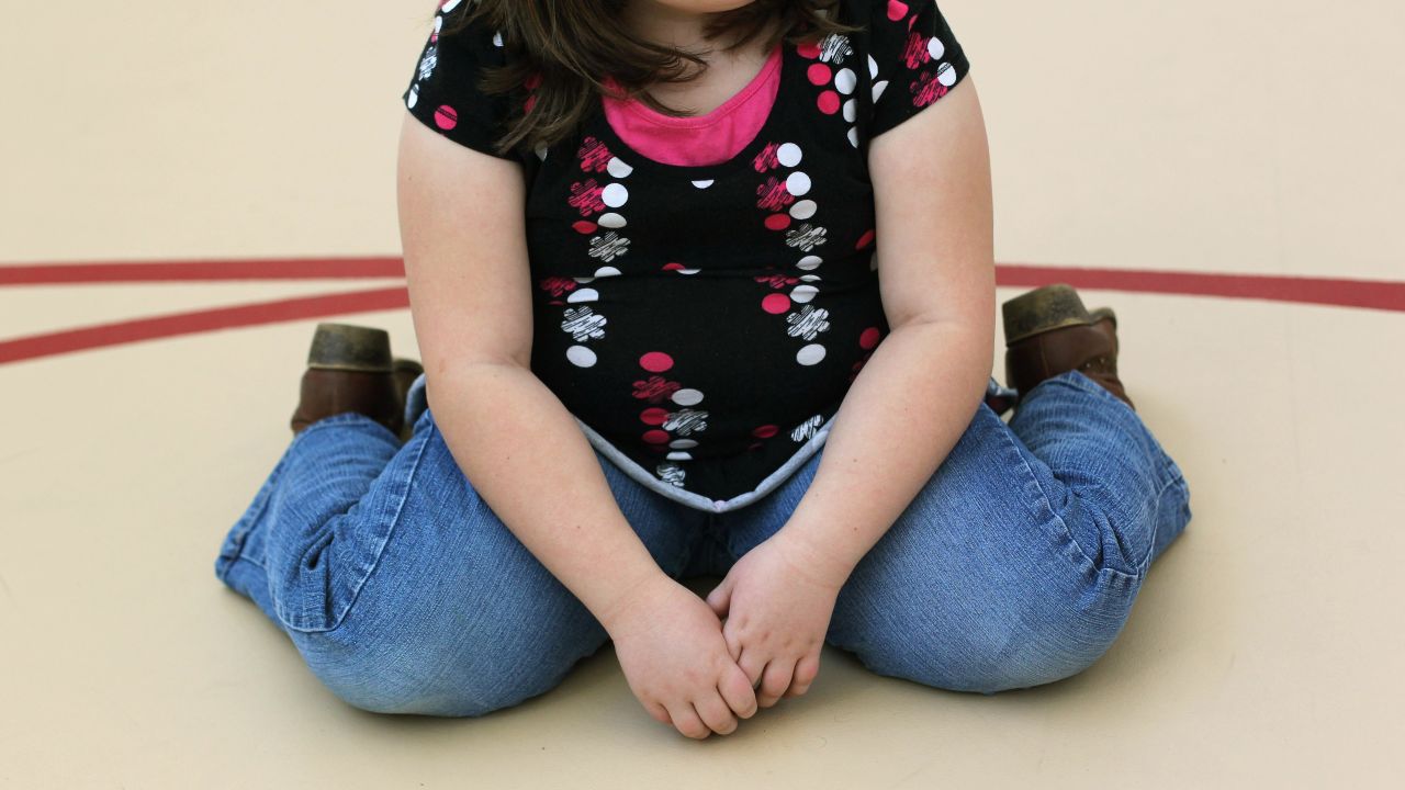 AURORA, CO - NOVEMBER 13:  A child sits on the gym floor during the Shapedown program for overweight adolescents and children on November 13, 2010 in Aurora, Colorado. The 10-week family-centered program held by the Denver area Children's Hospital teaches youth and their parents ways to lead a healthier more active lifestyle, as a longer lasting weight-loss alternative to dieting. Nationally, some 15 percent of children are overweight or obese, as are some 60 percent of adults.