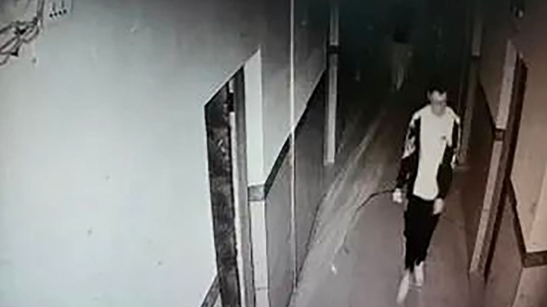 Esta captura de pantalla de las imágenes de la cámara de vigilancia muestra a Hu Xinyu caminando por un pasillo en su dormitorio.