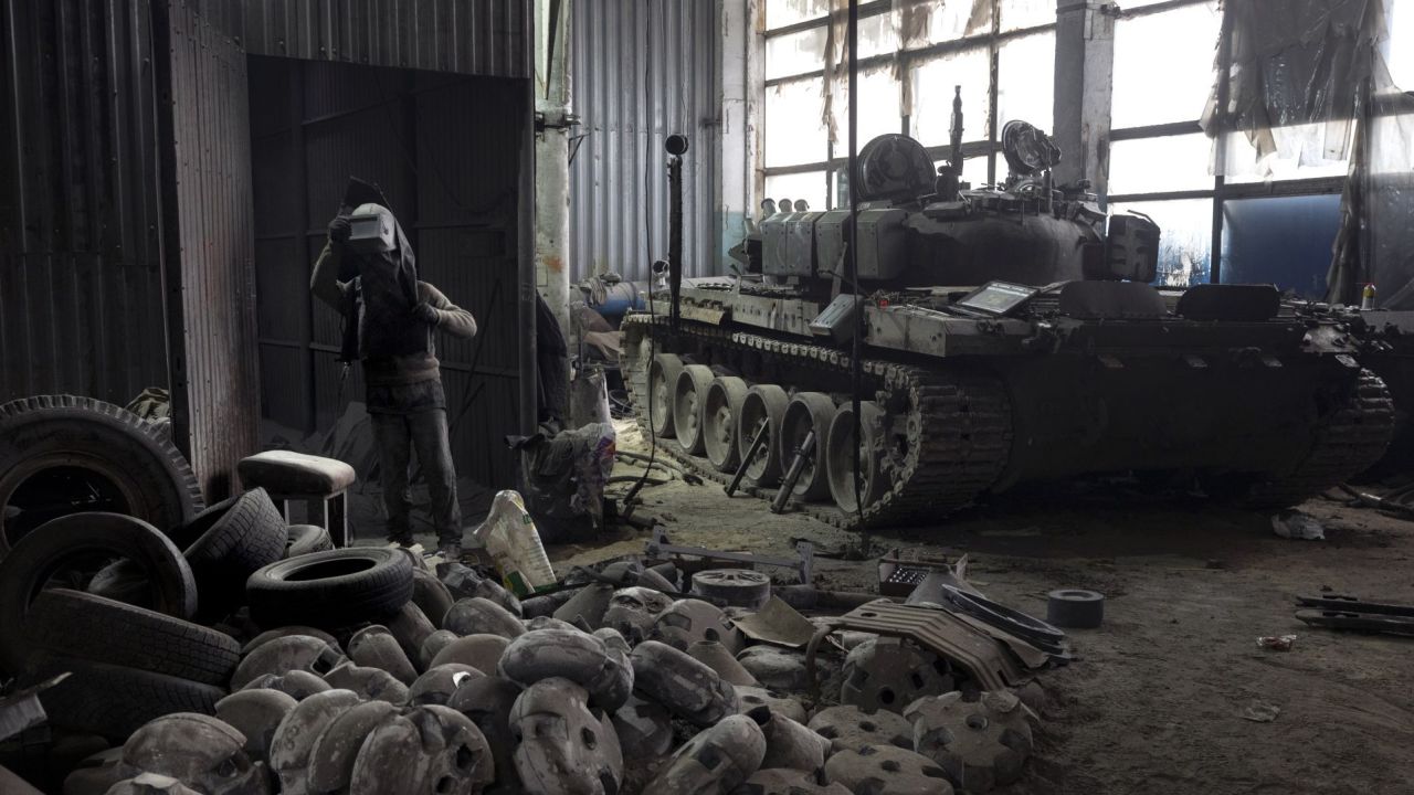 EASTERN UKRAINE - FEBRUARY 13: A captured Russian T-72B3 tank awaits repairs as a welder prepares to work on February 13, 2023 at a warehouse in eastern Ukraine. The Ukrainian crowdfunding organization Serhiy Prytula Charity Foundation funds the facility which refurbishes tanks and armored vehicles captured on the battlefield from retreating Russian forces. Such "trophy" vehicles have been crucial to resupply Ukrainian forces who often rely on older Soviet-era fleets, increasingly augmented by newer western weapons systems.