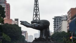 View of the Peace Monument sculpture in front of the Petroleos de Venezuela (PDVSA) headquarters in Caracas, on December 2, 2022. - Chevron signed this Friday "contracts for the continuation of operations and production activities" in Venezuela, after receiving a license from the United States to partially resume its activities in this country under embargo, the Venezuelan government reported. (Photo by Miguel ZAMBRANO / AFP)