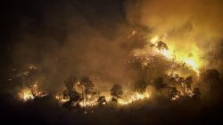 A forest fire burns on a mountain-side in Nakhon Nayok province, northeast of Bangkok on March 31, 2023. - Hundreds of Thai firefighters and soldiers battled a forest blaze less than 100 kilometres from Bangkok as the kingdom grapples with air pollution. (Photo by Jack TAYLOR / AFP)