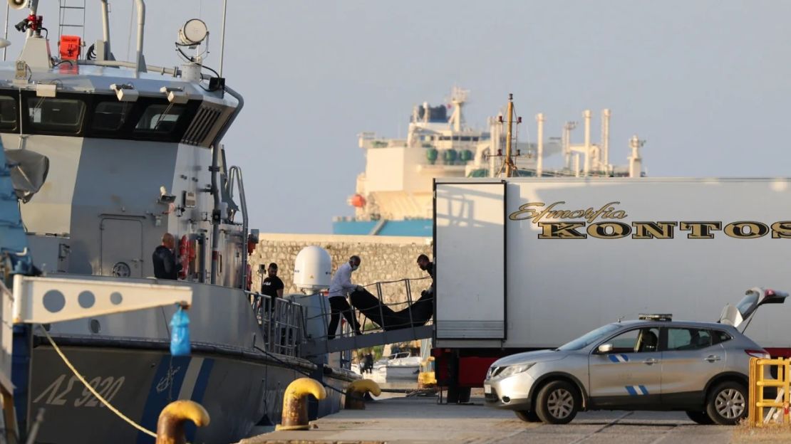 Trabajadores trasladan bolsas con cadáveres de personas fallecidas en la tragedia. Crédito: Stelios Misinas/Reuters