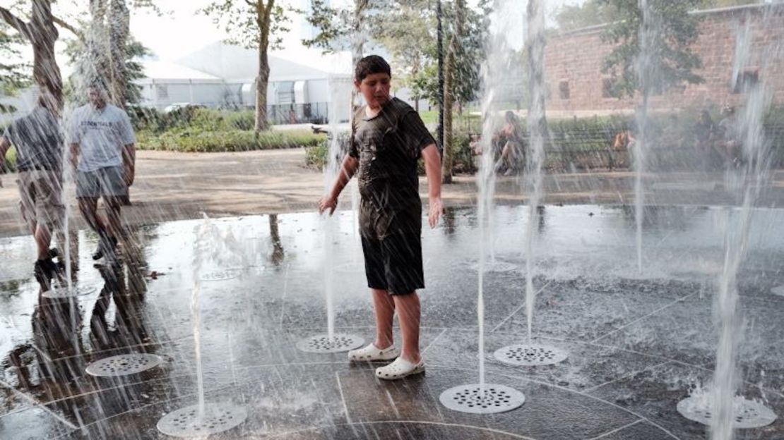 La gente se refresca en una fuente en Battery Park, en Manhattan, el jueves, en la ciudad de Nueva York.