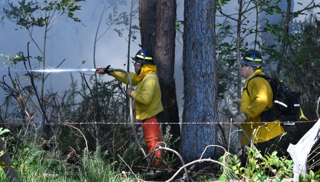 Miembros de una brigada de extinción de incendios forestales del Departamento de Territorio y Recursos Naturales de Hawai luchan contra un incendio en Kula, Hawai, el martes.