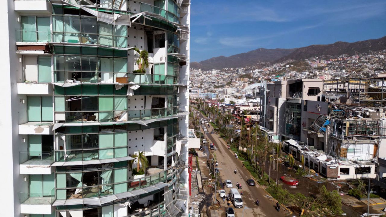 TOPSHOT - View of a building partially destroyed after the passage of Hurricane Otis in Acapulco, Guerrero State, Mexico, on October 26, 2023. Hurricane Otis caused at least 27 deaths and major damage as it lashed Mexico's resort city of Acapulco as a scale-topping category 5 storm, officials said Thursday, in what residents called a "total disaster." Otis crashed into Acapulco with furious winds of 165 miles (270 kilometers) per hour, shattering windows, uprooting trees and largely cutting off communications and road links with the region. (Photo by RODRIGO OROPEZA / AFP)
