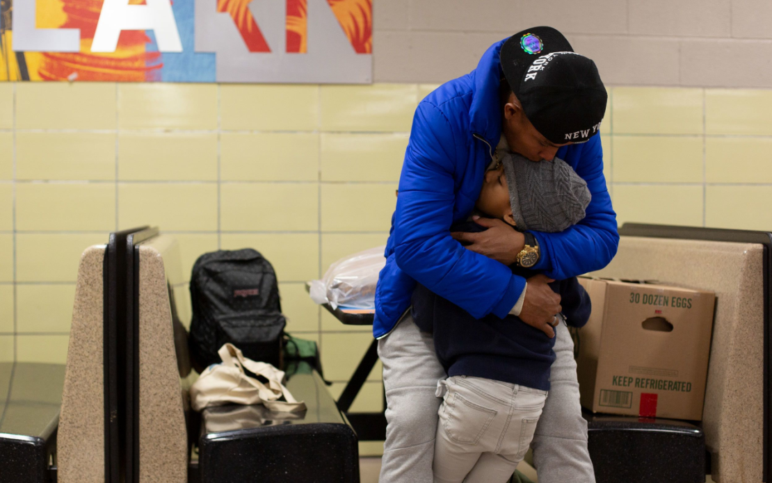 Franklin José Rivero abraza a su hijastro Jean Luis Hernández en la escuela secundaria Robert F. Wagner en Nueva York. Crédito Laura Oliverio/CNN.