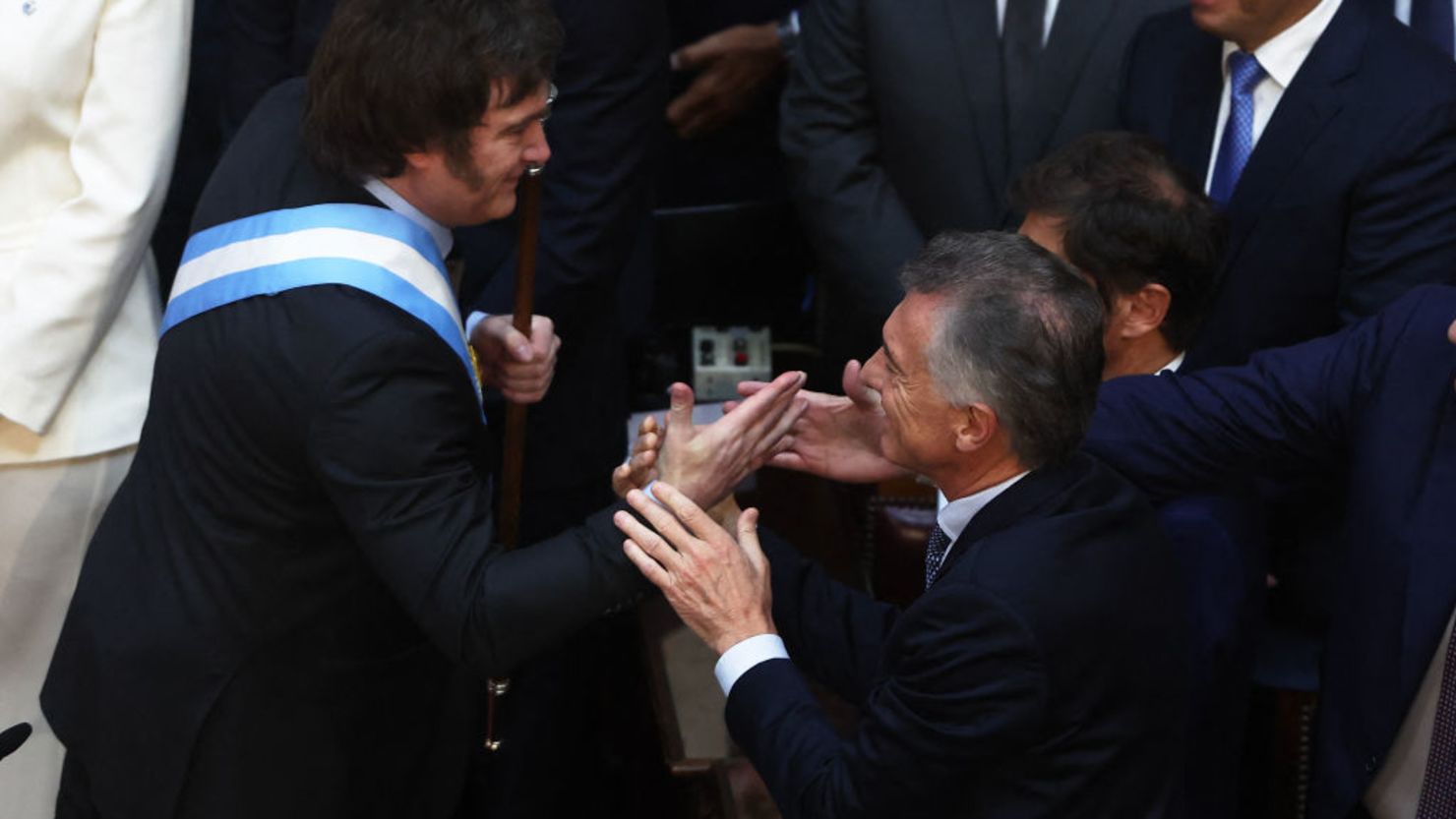 Argentina's new president Javier Milei (L) is greeted by ex-president (2015-2019) Mauricio Macri after swearing in during his inauguration ceremony at the Congress in Buenos Aires on December 10, 2023. Libertarian economist Javier Milei was sworn in Sunday as Argentina's president, after a resounding election victory fuelled by fury over the country's economic crisis. (Photo by ALEJANDRO PAGNI / AFP)