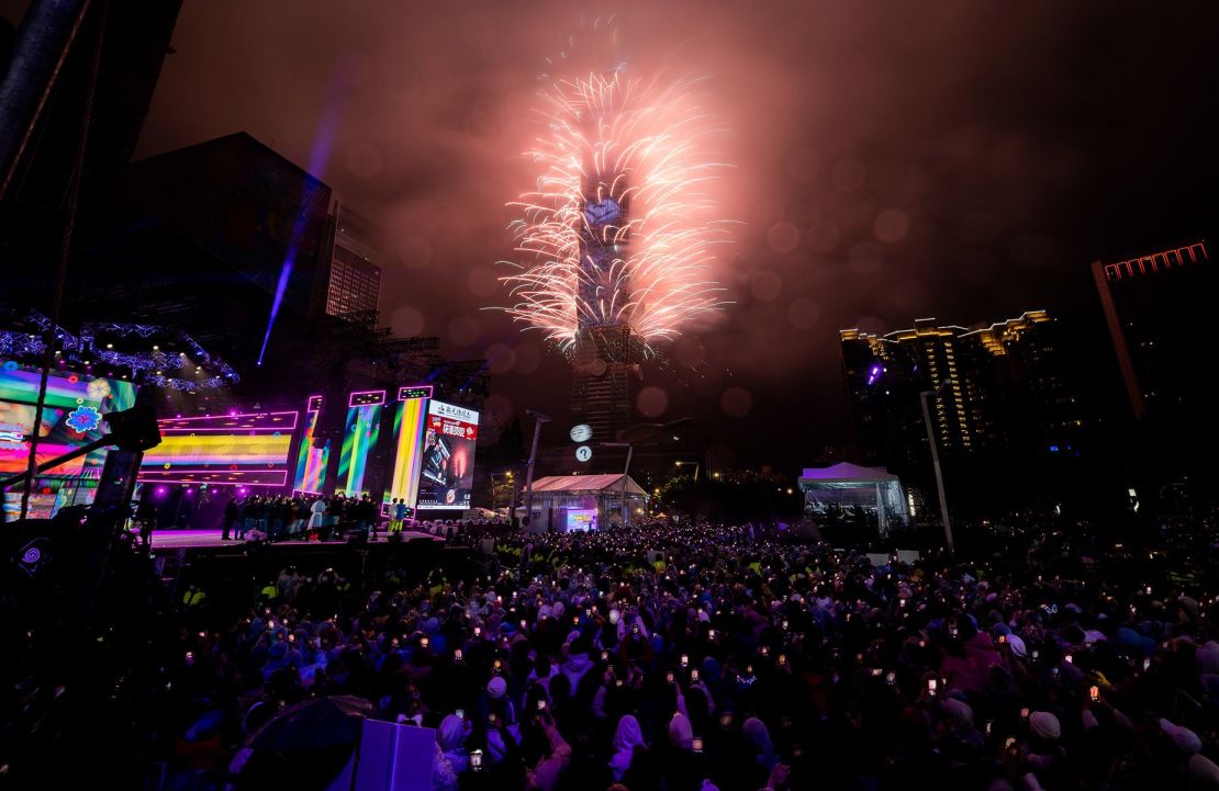 La gente celebra mientras los fuegos artificiales iluminan el horizonte desde el edificio Taipei 101 durante las celebraciones de Año Nuevo el 1 de enero de 2023 en Taipei, Taiwán. Crédito: Gene Wang/Getty Images