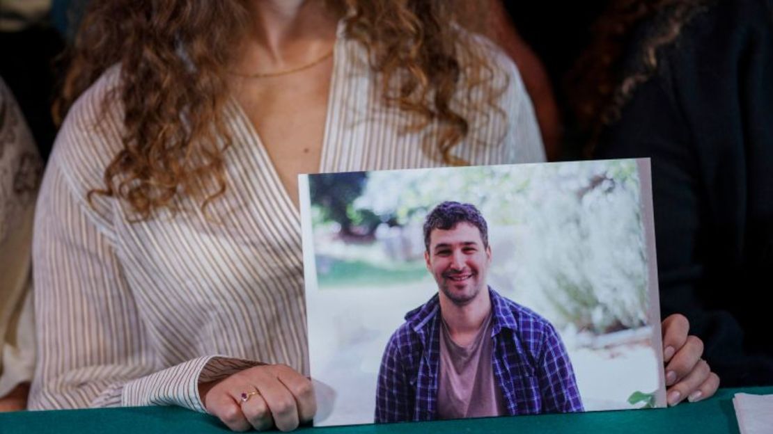 Naama Weinberg muestra una fotografía de su primo Itai Svirsky durante una conferencia de prensa de familiares de israelíes, celebrada el 26 de octubre de 2023.