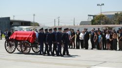 Chile's President Gabriel Boric and relatives of former Chilean president Sebastian Piñera receive the coffin with his body at the Pudahuel Airport in Santiago on February 7, 2024. Three days of mourning and funeral ceremonies got underway Wednesday for Chile's ex-president Sebastian Pinera, who died a day earlier when the helicopter he was piloting crashed into a lake. (Photo by RAUL BRAVO / AFP)