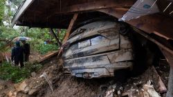 TOPSHOT - A car remains in the wreckage after a house and garage were destroyed by a landslide as a historic atmospheric river storm inundates the Hollywood Hills area of Los Angeles, California, on February 6, 2024. A powerful storm lashing California has left at least three people dead and caused devastating mudslides and flooding, after dumping months' worth of rain in a single day. (Photo by DAVID MCNEW / AFP)