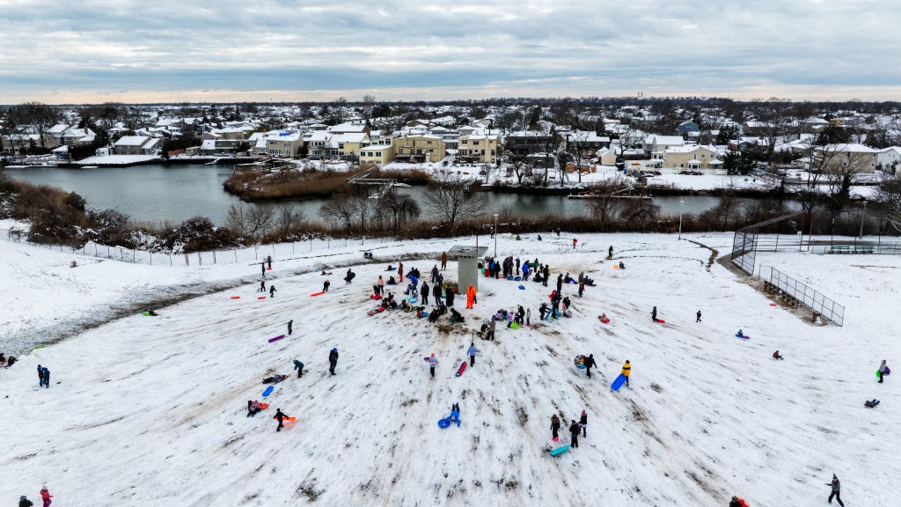 MERRICK, NEW YORK - FEBRUARY 13:  An aerial view of  people sledding after a large winter storm ed through the area on February 13, 2024 in Merrick, New York.  Much of the Northeast is experiencing snow, wind and freezing temperatures with many businesses closed and schools in New York City going remote for the day.