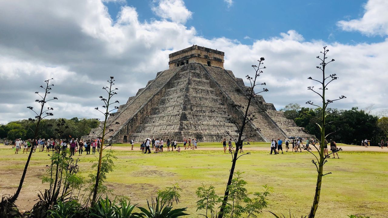 TOPSHOT - People visit the Kukulcan Pyramid at the Mayan archaeological site of Chichen Itza in Yucatan State, Mexico, on February 13, 2019. (Photo by DANIEL SLIM / AFP)