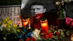 This photograph taken in Sofia on March 1, 2024, on the day of his funeral in Moscow, shows candles, flowers left as a tribute to Russian opposition leader Alexei Navalny. Navalny, whose death in an Arctic prison was announced on February 16, was Russian President Vladimir Putin's most prolific critic for over a decade, blasting what he called rampant corruption and refusing to back down even after being poisoned. (Photo by Nikolay DOYCHINOV / AFP)