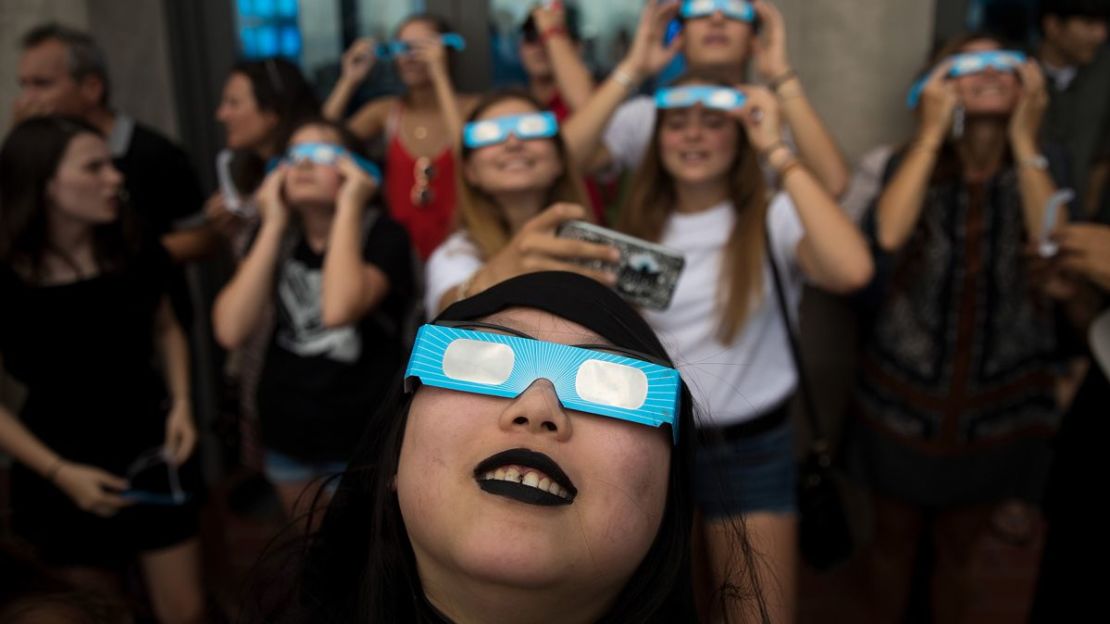 Espectadores ven un eclipse solar parcial en agosto de 2017 en el observatorio Top of the Rock en el Rockefeller Center de Nueva York.