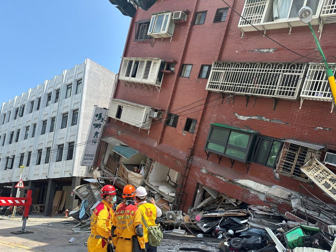 Firefighters work at the site where a building collapsed after the earthquake, in Hualien.