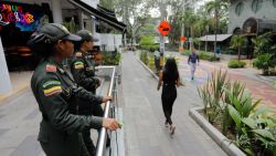 Policewomen patrol a street in the El Poblado neighborhood in Medellin, Colombia, on April 2, 2024. The Medellin mayor's office announced on April 1 that it is restricting for six months the "demand or solicitation of sexual services" in tourist areas of the Colombian city, following the case of an American man who was seen with two girls in a hotel. (Photo by JAIME SALDARRIAGA / AFP)