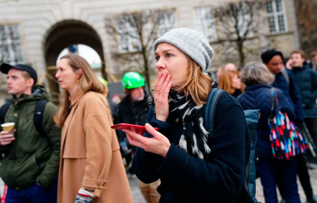 Los espectadores conmocionados observan cómo el fuego envuelve el edificio histórico en el centro de Copenhague.