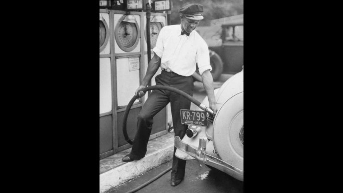 Owens llena gasolina en un automóvil en julio de 1935. Trabajó como encargado de una gasolinera para ayudar a pagar su universidad.