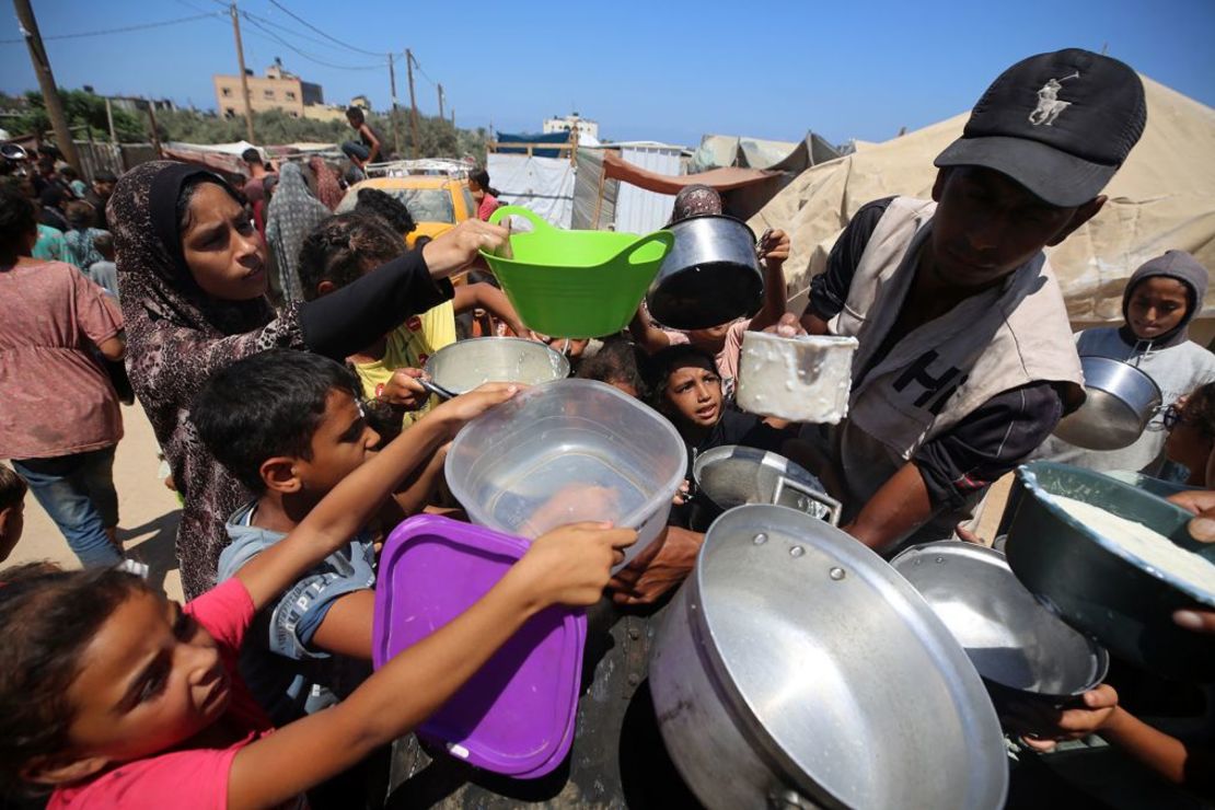 Niños desplazados se reúnen para recibir alimentos cocinados por una organización benéfica en la gobernación de Deir al-Balah, en el centro de Gaza, el 8 de agosto. Crédito: Majdi Fathi/NurPhoto/Getty Images