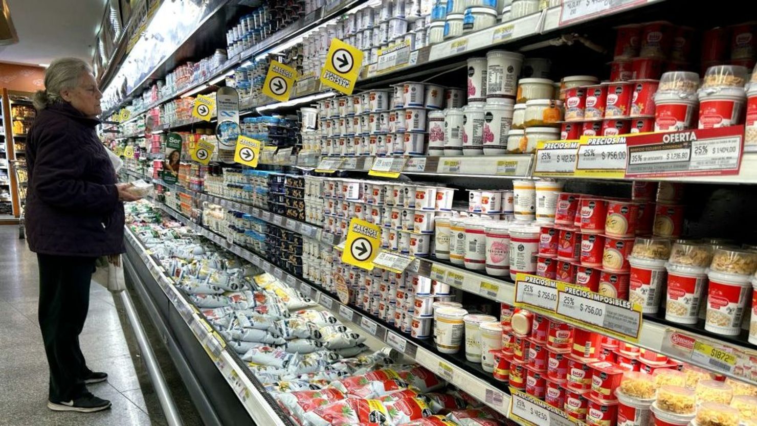 Una mujer revisa los precios de los productos lácteos en un supermercado de Buenos Aires, el 23 de agosto de 2024.