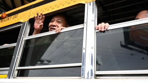A released Nicaraguan political prisoners waves on a bus leaving the Guatemala City Air Base on September 5, 2024. The United States said Thursday it had secured the release of 135 political prisoners from Nicaragua, the latest mass transfer by President Daniel Ortega's increasingly authoritarian government. (Photo by JOHAN ORDONEZ / AFP)