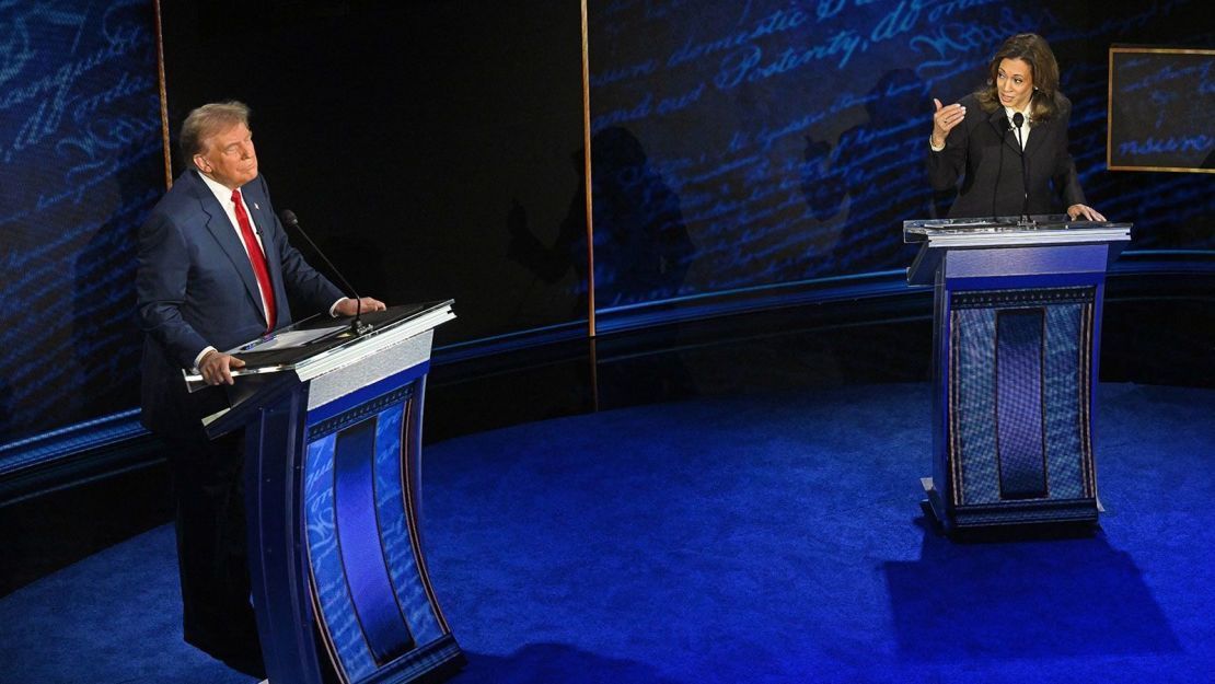 Vice President and Democratic presidential nominee Kamala Harris speaks as former President and Republican presidential nominee Donald Trump listens during a presidential debate at the National Constitution Center in Philadelphia, Pennsylvania, Sept. 10, 2024.