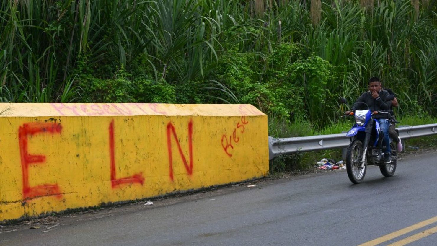 Una motocicleta pasa junto a un cartel que dice "ELN," que se refiere al grupo guerrillero Ejército de Liberación Nacional, en Corinto, provincia de Valle del Cauca, Colombia, el 6 de junio de 2024.