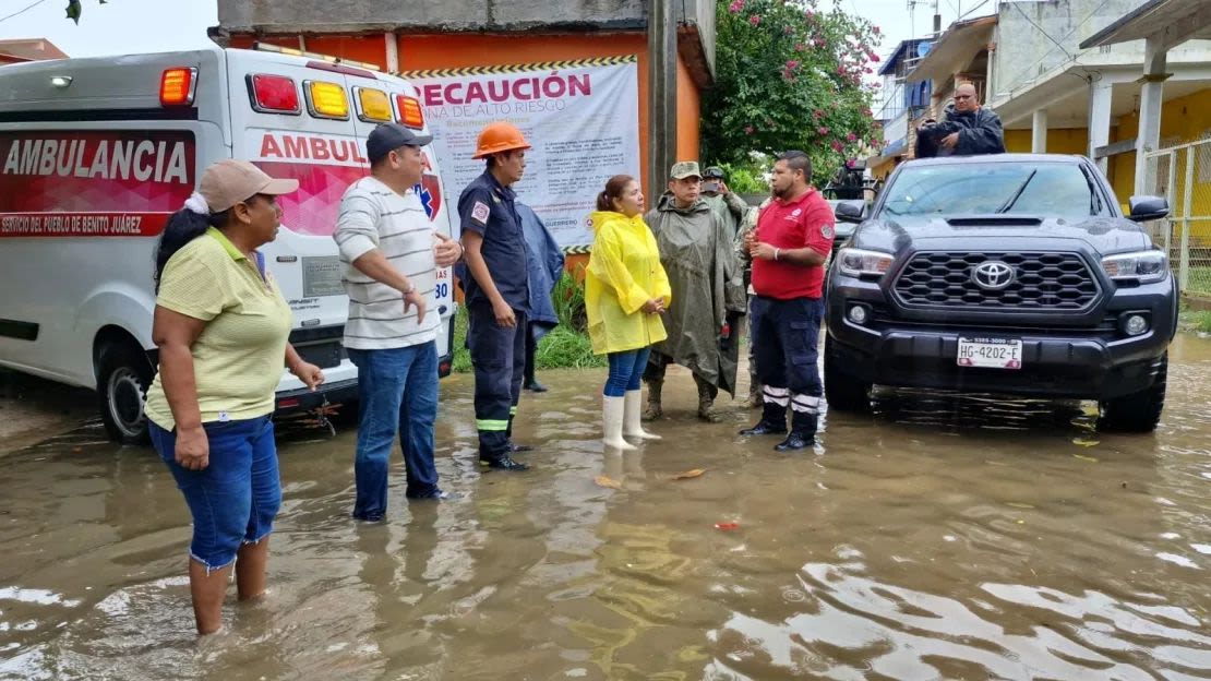 Georgina de la Cruz Galeana, Benito Juárez, Guerrero's municipal president, and other individuals coordinate with response personnel to tour the danger areas. Courtesy Georgina de la Cruz Galeana