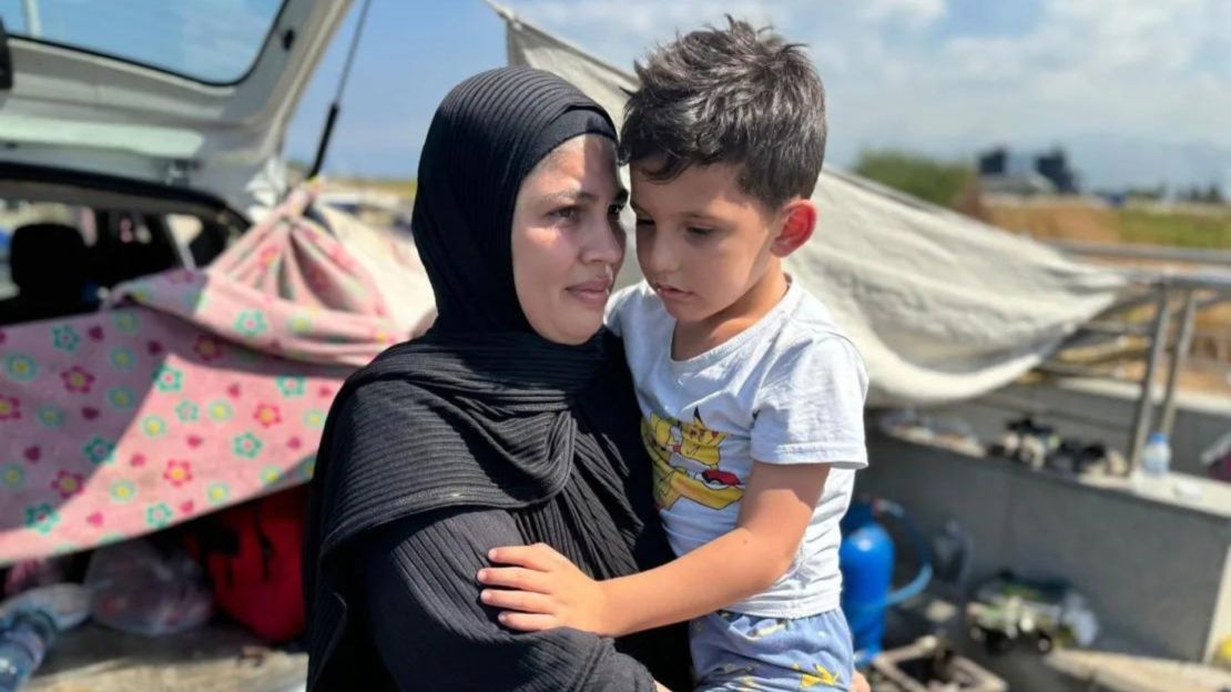 Umm Mohammed and her five-year-old son, who survived Israeli bombing in southern Lebanon, are now sheltering under a tarpaulin on the seashore in Beirut. Credit: Jomana Karadsheh/CNN