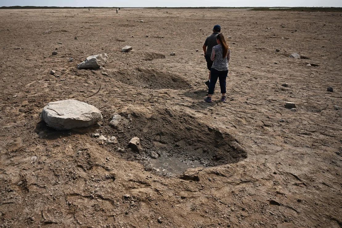 The public walks through a field of debris on the launch pad on April 22, 2023, after SpaceX's Starship spacecraft lifted off on April 20 for a flight test from the company's Starbase facility in Boca Chica , Texas. (Photo: Patrick T. Fallon/AFP/Getty Images).