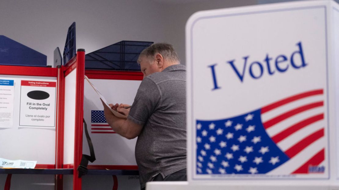 A voter with his ballot during early in-person voting at a polling station at the Elena Bozeman Government Center in Arlington, Virginia, on September 20, 2024.