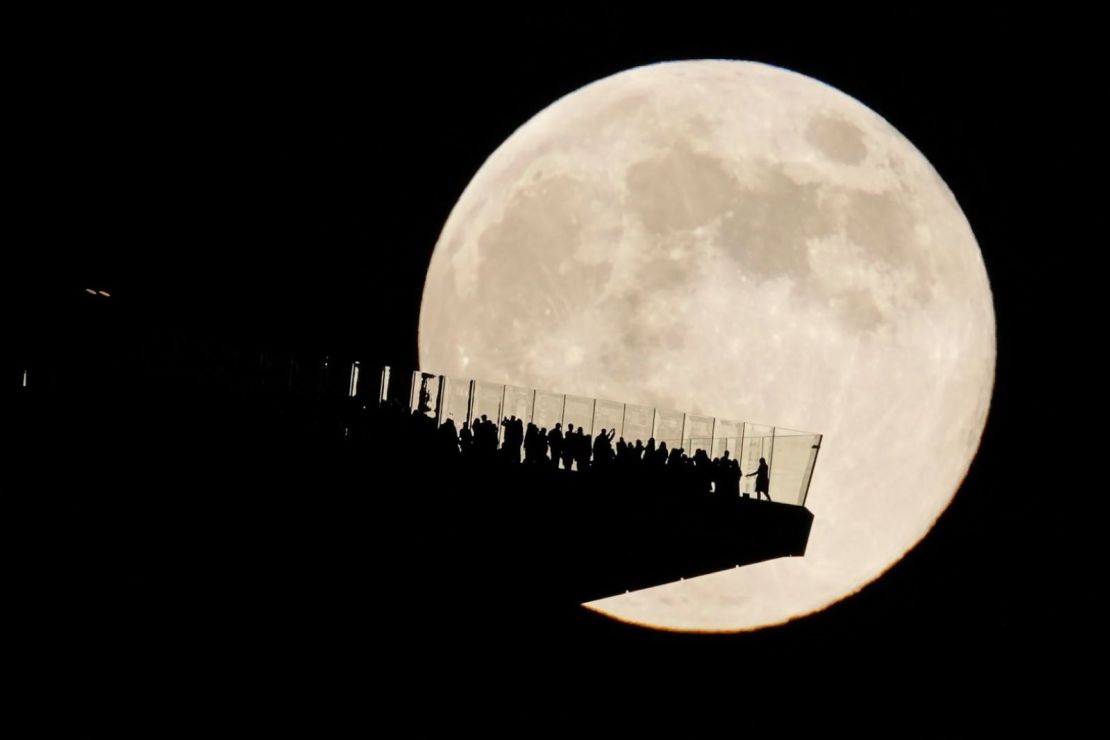 Desde Hoboken, Nueva Jersey, se puede observar la luna brillando detrás de una plataforma de observación en la ciudad de Nueva York. Crédito: Seth Wenig/AP