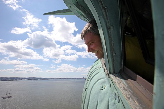 2009: Un turista observa la ciudad de Nueva York desde la corona de la Estatua de la Libertad.